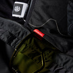 The 686 Gore-Tex GT Shell Jacket in black has an insulated hood and is made with waterproof fabric.