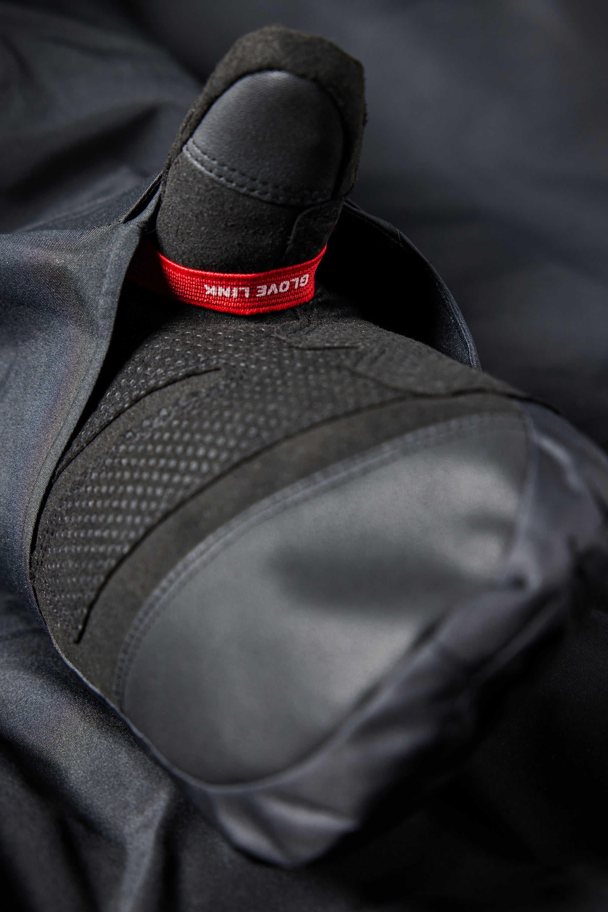 The 686 Women's GORE-TEX Willow Insulated Jacket 2025 is shown in black with a red glove link on the right wrist.
