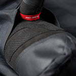 The jacket is primarily black with red accents and has an insulated hood.