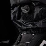 The 686 brand Gore-Tex GT pants are showcased in this image from the front view, featuring a black color with white stitching and a zippered leg.