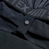 Women's black shell pant button placket and textured strap detail