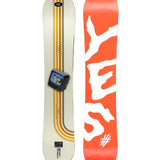 The Yes brand's 2025 model snowboard has an orange base with white lettering and is displayed in a side view.