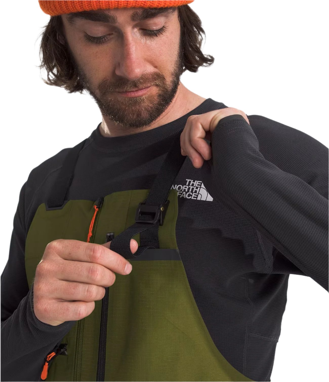 North Face Men's Ceptor Shell Bib - A man wearing a black and green bib with orange accents, featuring a white logo on the chest.