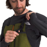North Face Men's Ceptor Shell Bib - A man wearing a black and green bib with orange accents, featuring a white logo on the chest.