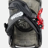 Burton Junior's Grom Snowboard Bindings 2025 - A black snowboard binding with a red plastic strap and white lettering on the front.