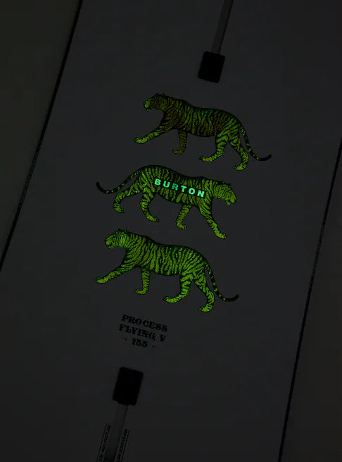 Burton Process Board Flying V Snowboard 2025 - A black snowboard with a white and green striped pattern on its top side.