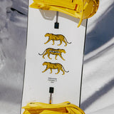 Burton Process Board Flying V Snowboard 2025 - White snowboard with yellow and black striped tiger graphics on top.