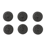 Burton Aluminum Stud Stomp Pad - A round, black stomp pad with a circular indentation in the center and "BURTON" embossed around the edge.