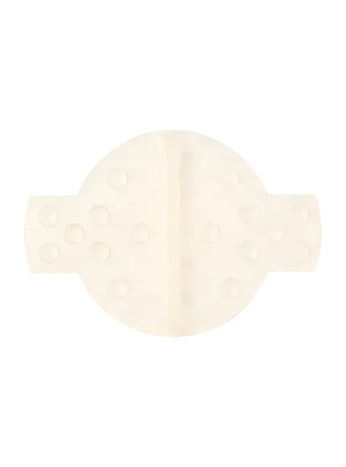 Burton Large Scraper Stomp Pad - A cream-colored stomp pad with a circular shape and a vertical line down the center, featuring six round holes on its left side.