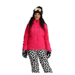 Obermeyer Women's Glade Insulated Jacket - A bright pink jacket with a high collar and zippered pockets, featuring black zippers and a black drawstring at the waist.