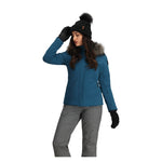 Obermeyer Women's Tuscany Elite Insulated Jacket - A blue jacket with a fur-lined hood, featuring a zippered front and two side pockets.