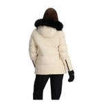 Obermeyer Women's Circe Down Jacket - A cream-colored down jacket with a black faux fur-lined hood and zippered pockets.