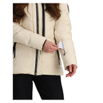 Obermeyer Women's Circe Down Jacket - A cream-colored down jacket with black zippers and a black strap on the left shoulder.