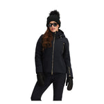 Obermeyer Women's Cristallo Insulated Jacket 2025 - A black insulated jacket with gold zippers and a high collar, featuring a zippered chest pocket on the left side.