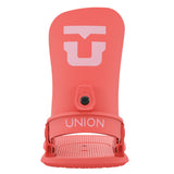 Union Women's Legacy Snowboard Bindings 2025 - A coral-colored snowboard binding with a large white "U" logo on top and a black circular screw in the middle.