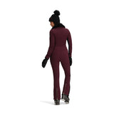 Obermeyer Women's Katze Insulated Suit 2025 - A burgundy insulated ski suit with a black fur-trimmed hood and zippered pockets on the side.