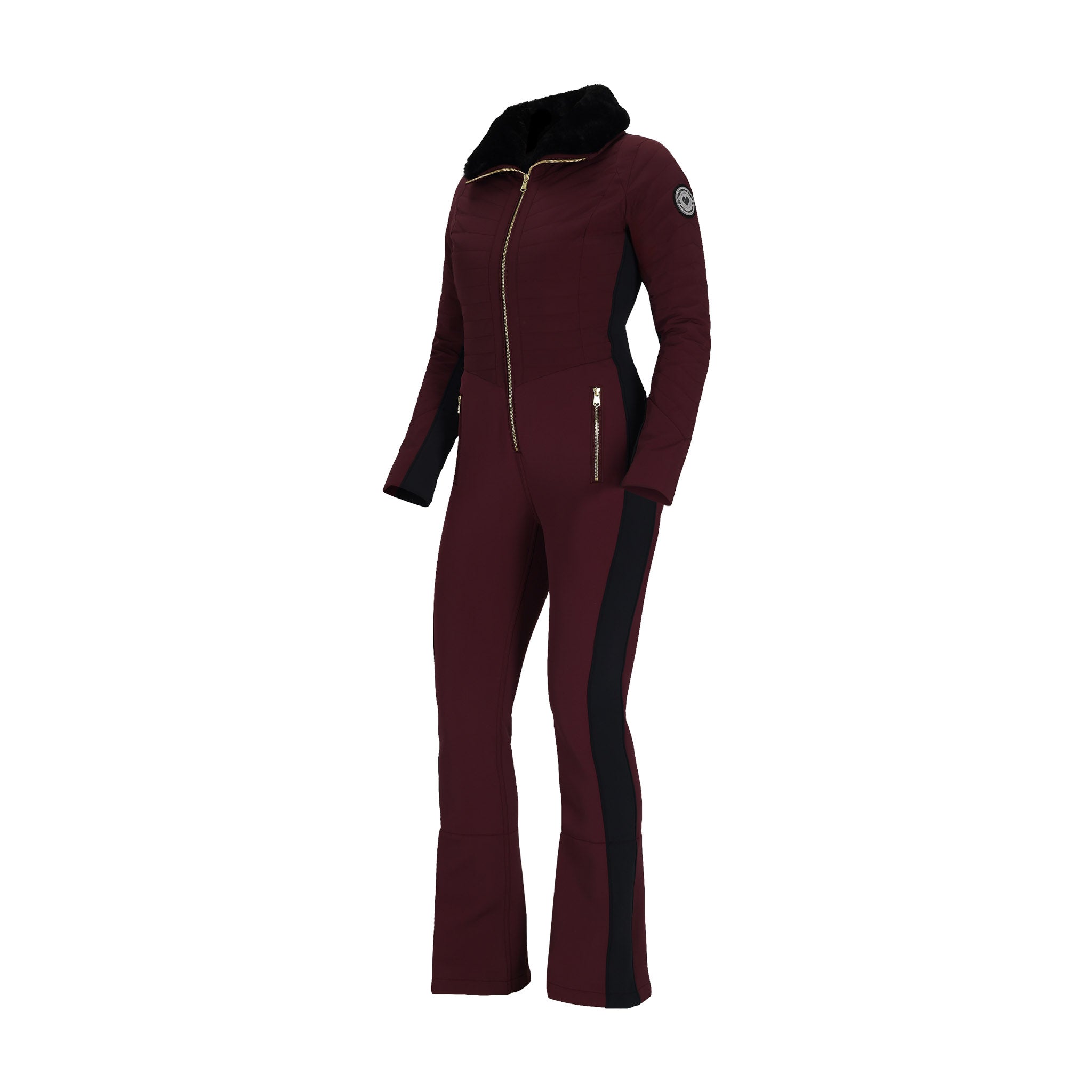 Obermeyer Women's Katze Insulated Suit 2025 - A burgundy insulated suit with a black faux fur hood and gold zipper.