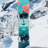 Burton Women's Yeasayer Snowboard 2025 - A blue snowboard with a pink cloud design on top of a snowy mountain.