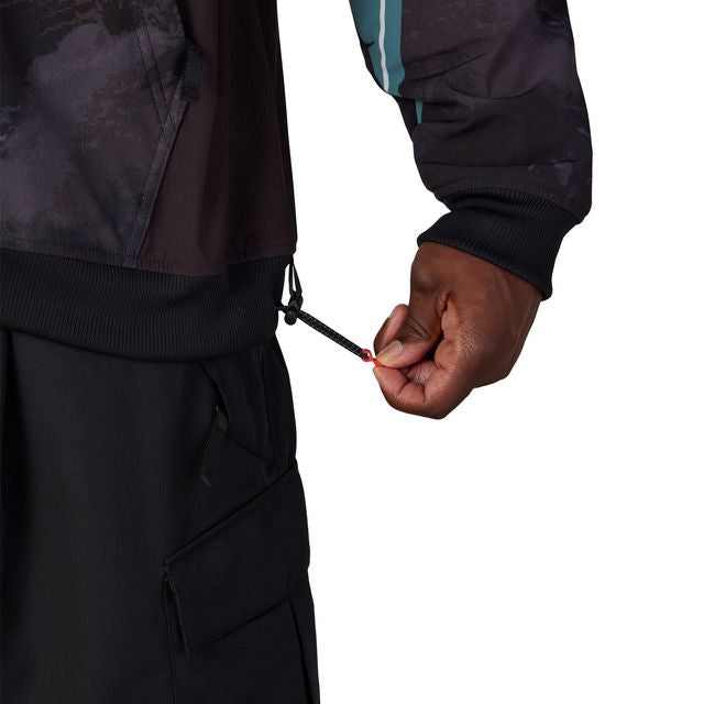 Waterproof team hoody detail: drawstring cinch hem and teal-accent sleeve