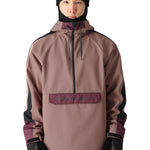 The 686 brand's waterproof anorak jacket has a light brown body with dark purple accents on the shoulders and upper arms.