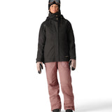 The 686 Black Magic insulated bib features a black color and appears to be worn by a woman in a front view.