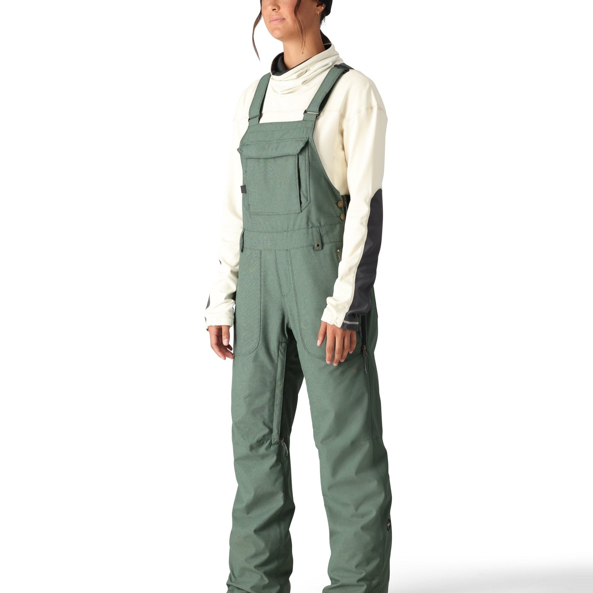 The 686 brand's Black Magic insulated bib features a sleek black design with white accents on the side view.