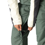 The 686 Women's Black Magic Insulated Bib 2025 is shown in black with an insulated hood.