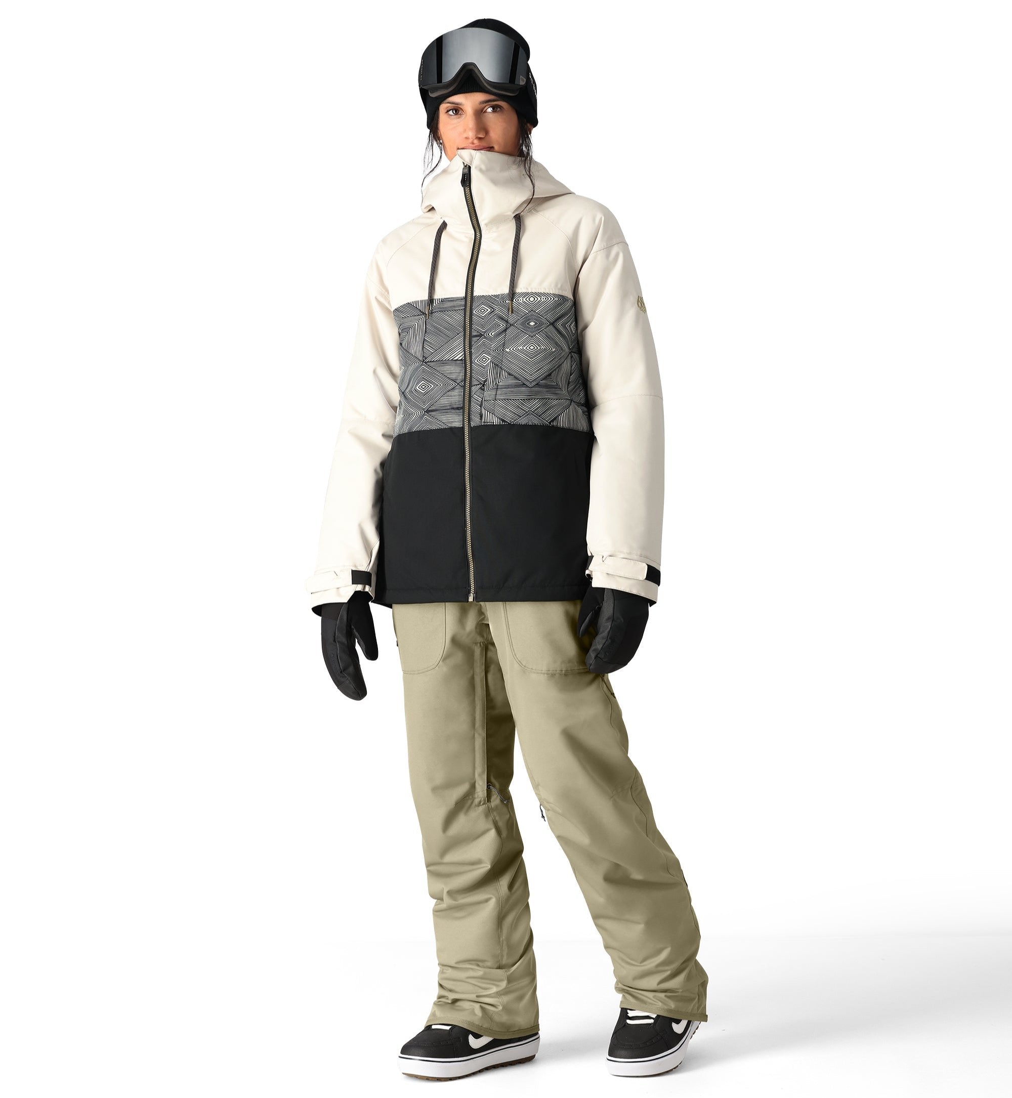 The 686 Black Magic insulated bib pants are primarily black with a geometric pattern on the front in shades of white and grey.