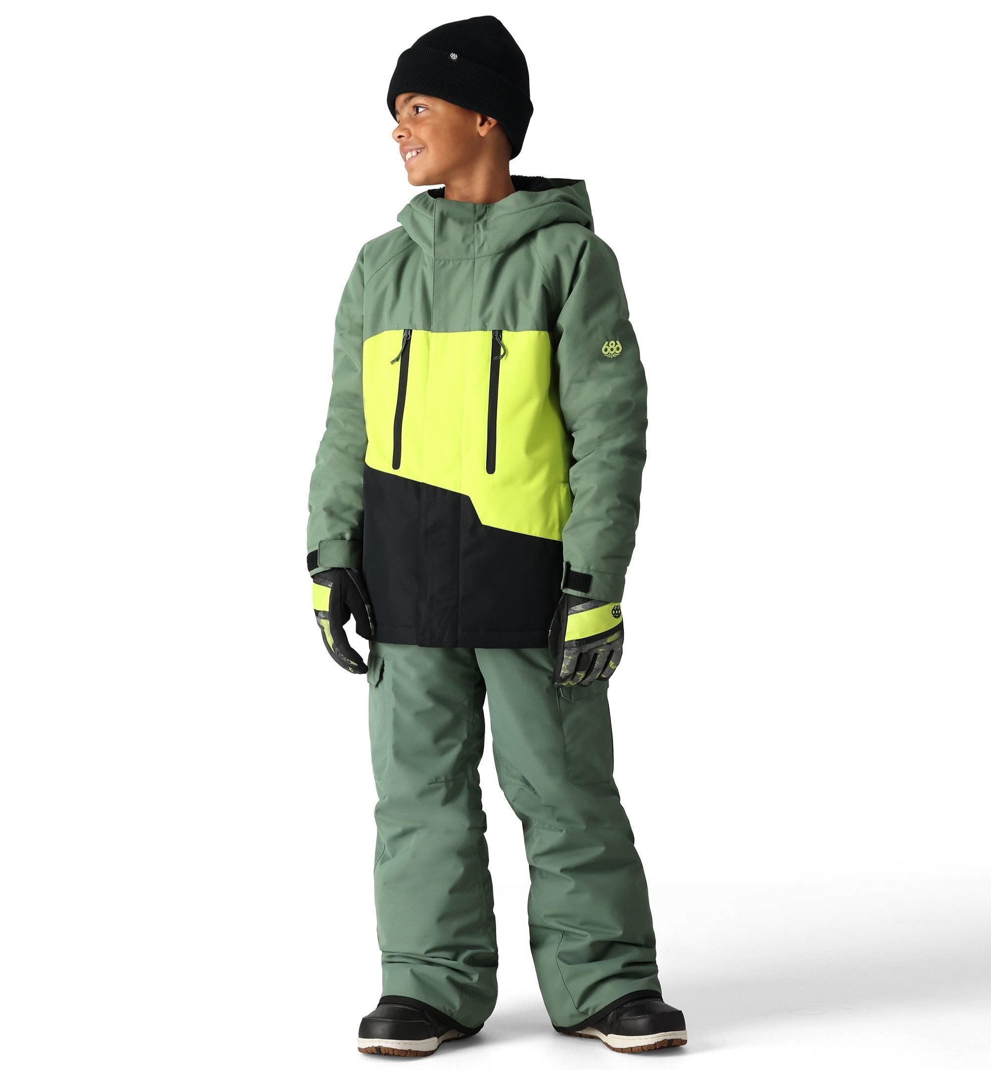 The 686 Youth GEO Insulated Jacket 2025 is predominantly sage green with a neon yellow and black geometric design on the front.
