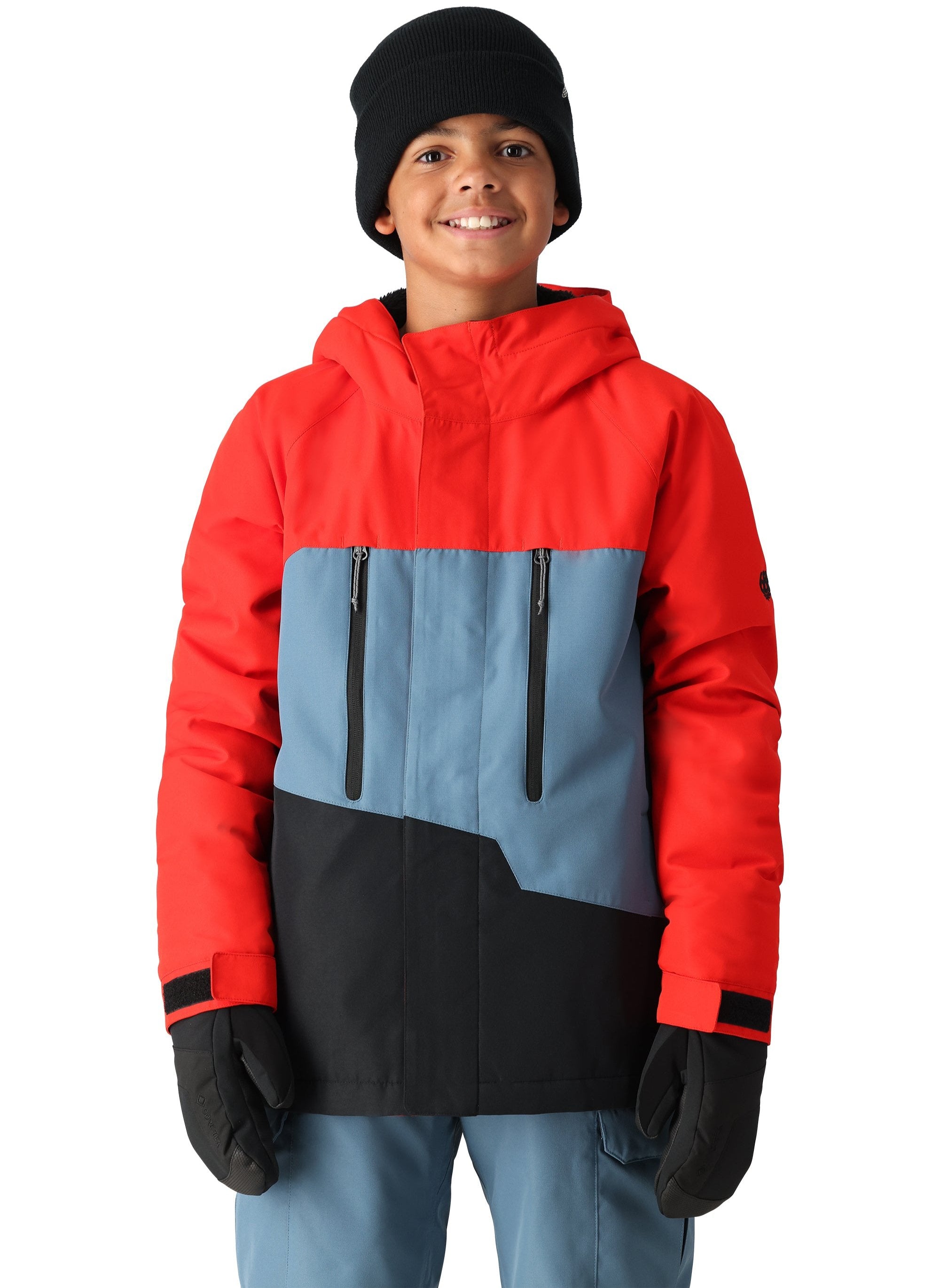 The 686 Youth GEO Insulated Jacket has a red and blue color scheme with a black front panel and two zippered pockets.