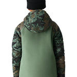 The 686 Hydra Insulated Jacket in green camouflage pattern features a hood and appears to be worn by an unseen model.