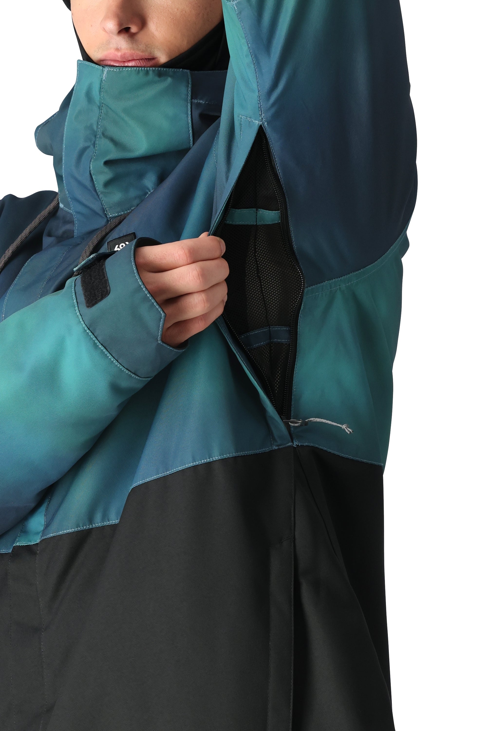 The 686 Foundation Insulated Jacket 2025 is shown from the front with a black and teal ombre design.