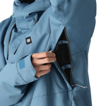 The 686 Foundation Insulated Jacket 2025 in light blue has an insulated hood and appears to be fully zipped up.