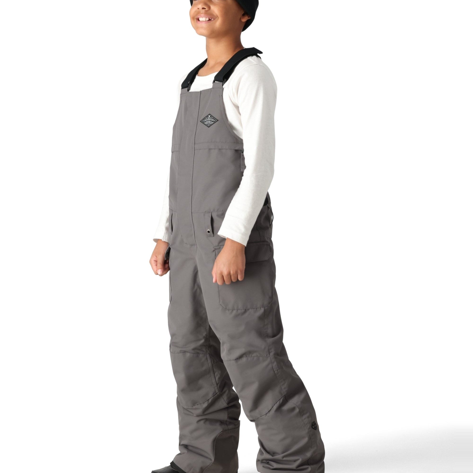 The 686 Boy's Frontier Insulated Bib 2025 has a gray color with an adjustable BOA dial on the left strap.