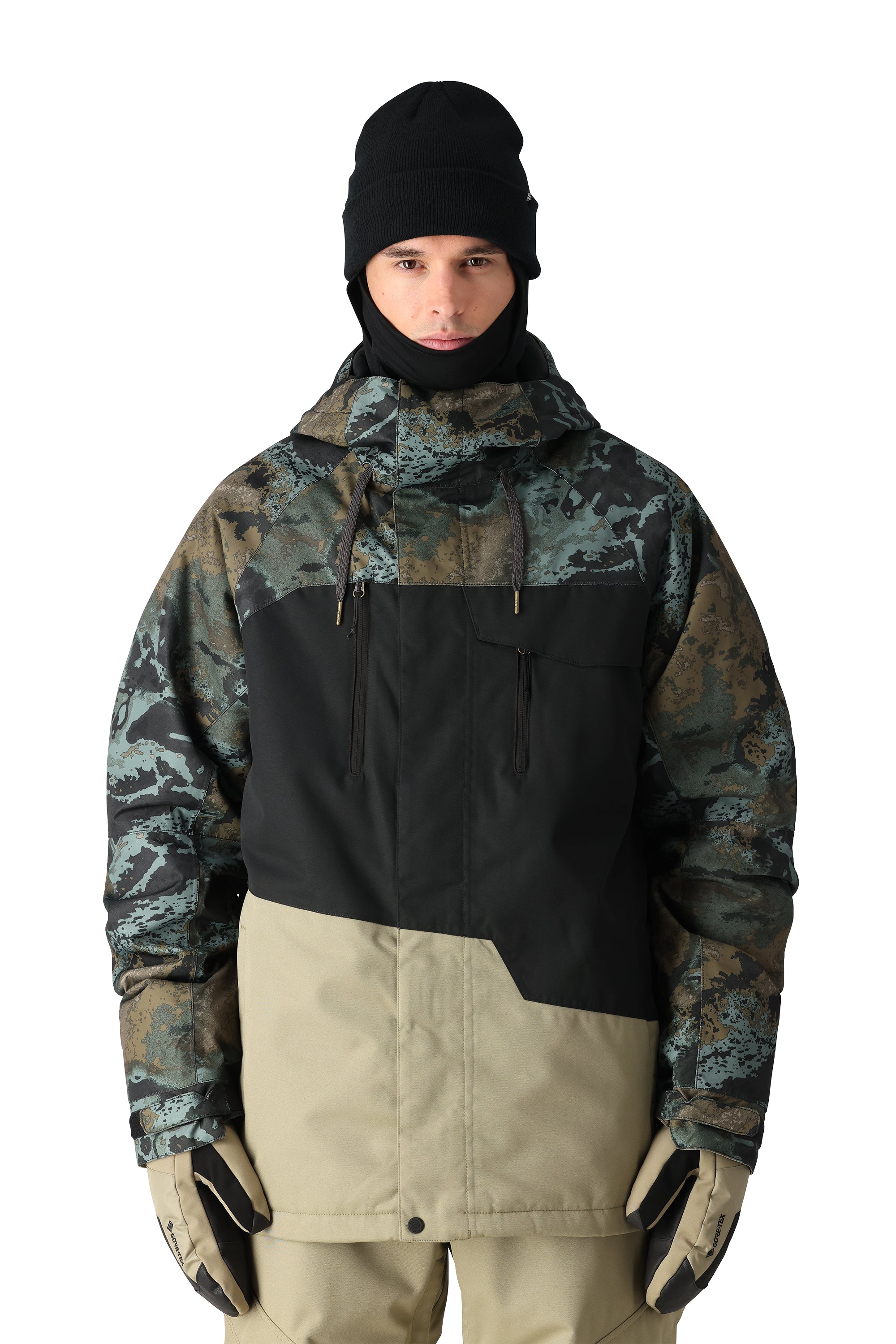 The 686 Geo Insulated Jacket in camouflage pattern has a black front panel and tan accents.