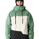 The 686 Geo Insulated Jacket 2025 is depicted in green with a black and white stripe across the chest.