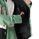 The 686 Geo Insulated Jacket 2025 is green with an insulated hood and zippered pockets.