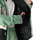 The 686 Geo Insulated Jacket 2025 is green with an insulated hood and zippered pockets.