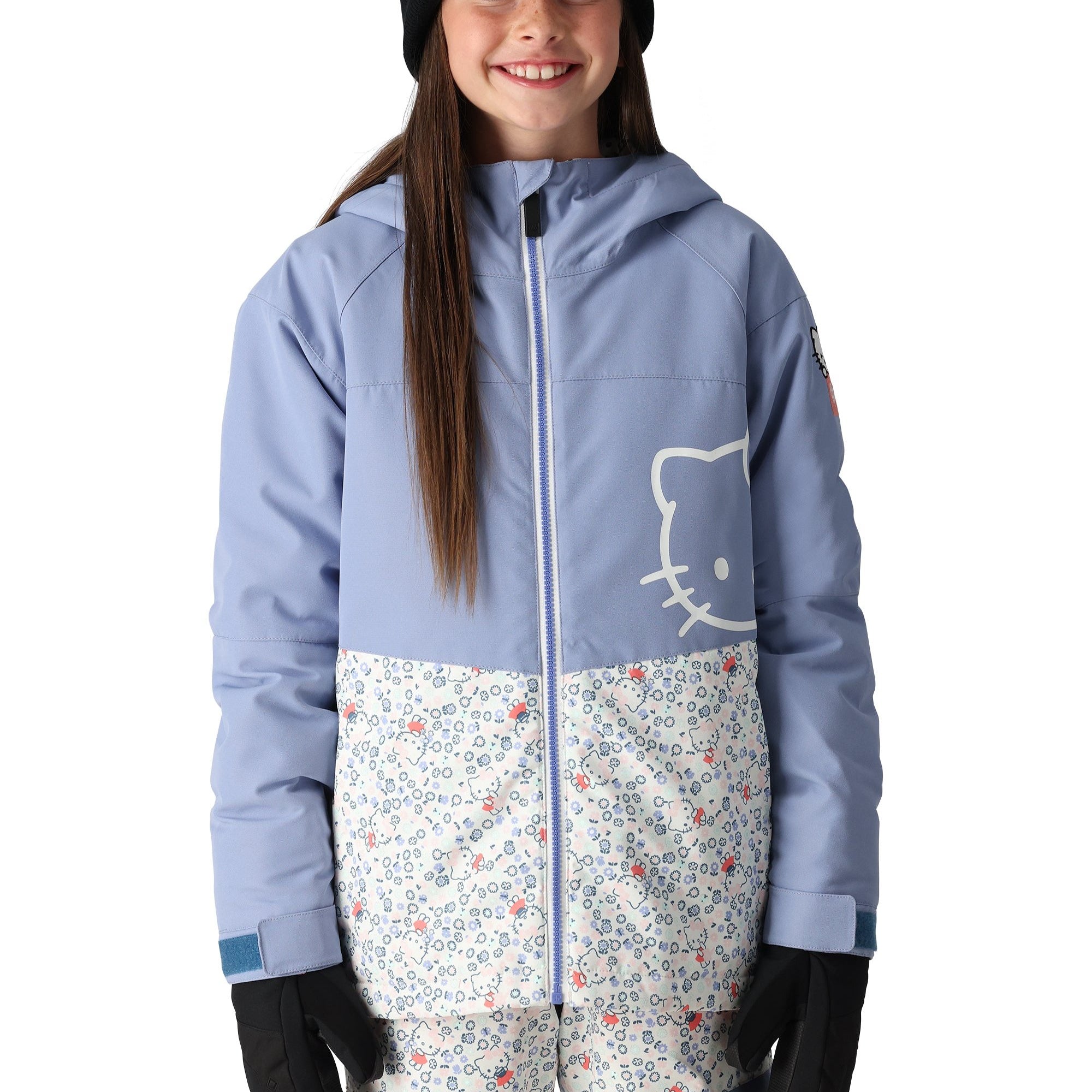 The 686 Girl's Athena Insulated Jacket 2025 is primarily light blue with a white graphic on the front and has an insulated hood.