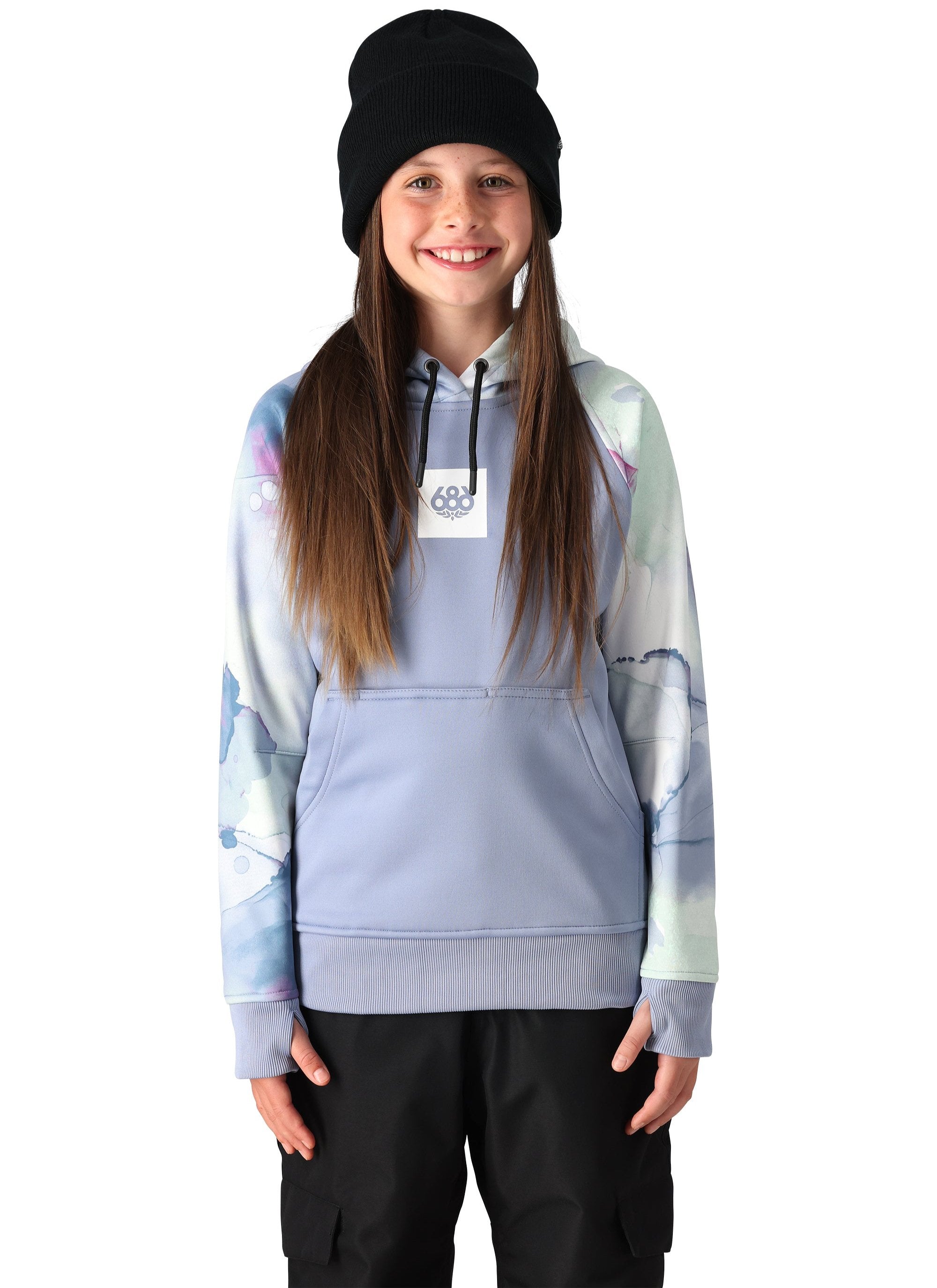A young girl with long brown hair wearing a black beanie and a light blue pullover hoody with a white tag on the front that reads "686" in dark blue letters.