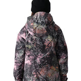 The 686 Girl's Hydra Insulated Jacket 2025 has a black base with a pink and white abstract pattern, featuring an insulated hood.