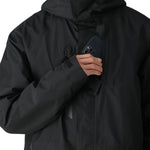 The 686 Gore-Tex Core Shell Jacket 2025 in black has an insulated hood and appears to be zipped up on a model.
