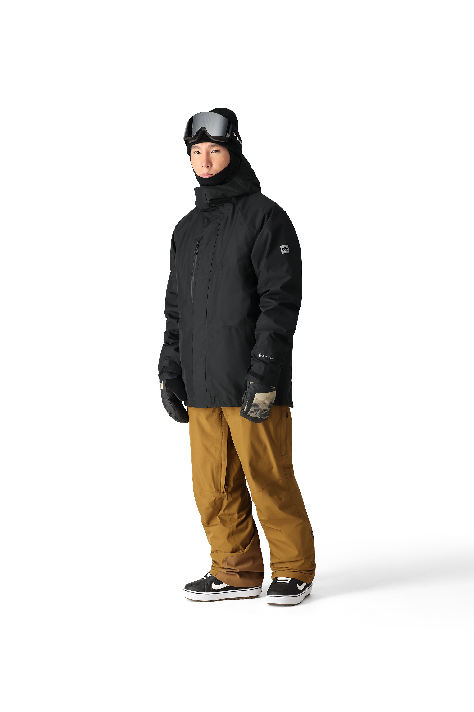 The 686 Gore-Tex Core Shell Jacket in black has an insulated hood and a zippered chest pocket.