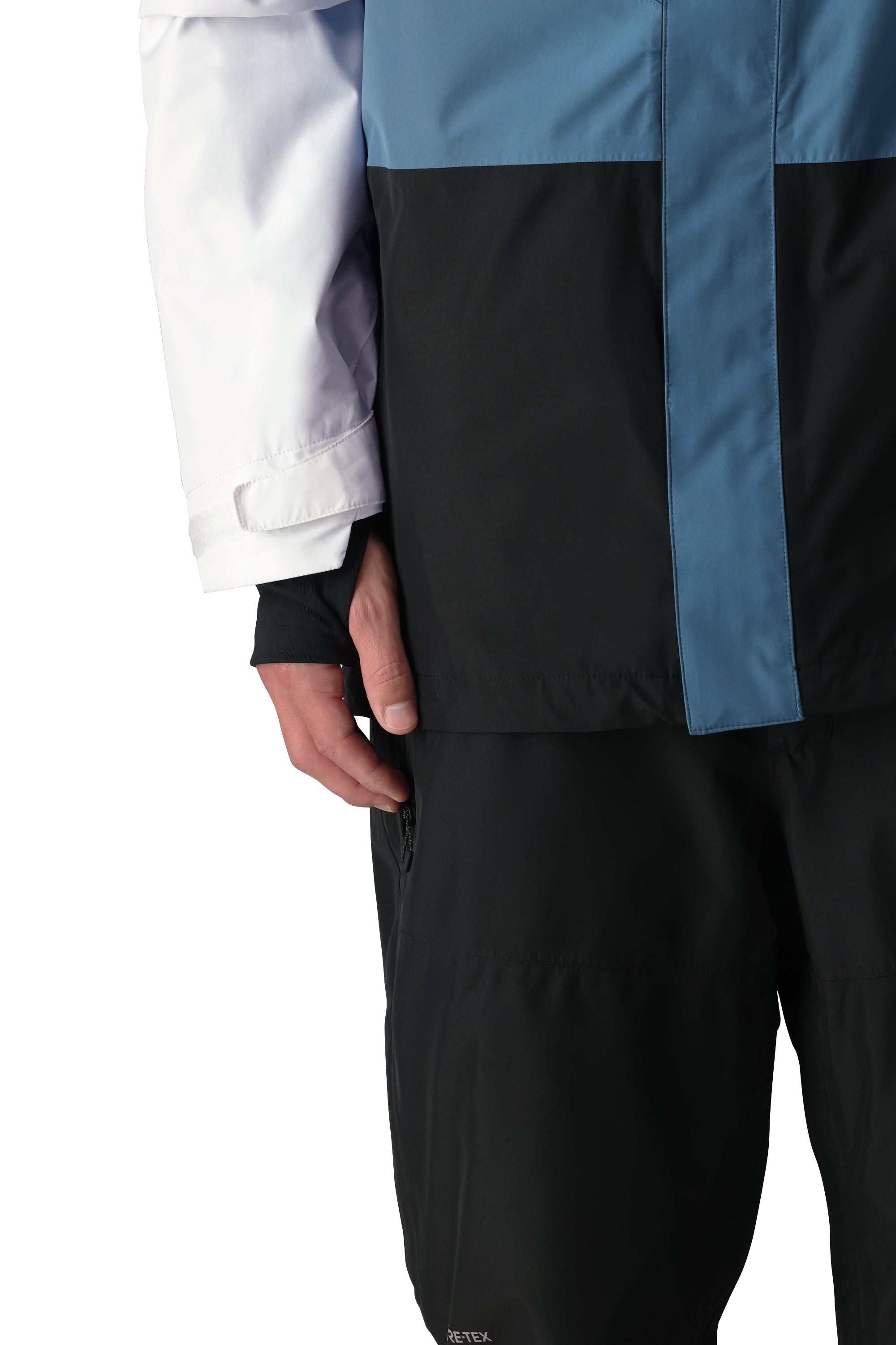 The 686 GORE-TEX Core Shell Jacket 2025 features a predominantly black design with light blue accents on the chest and shoulders.