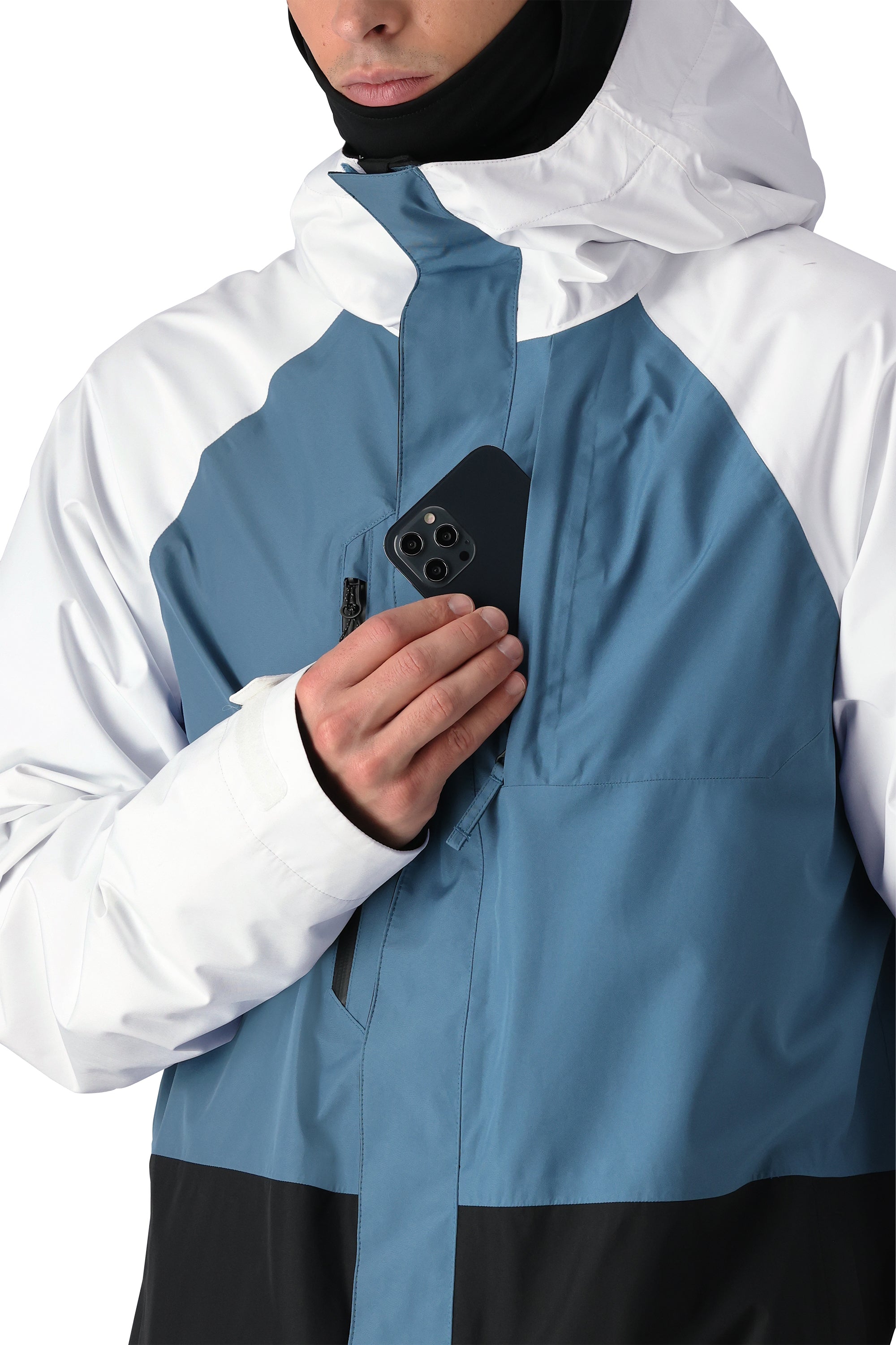 The 686 Gore-Tex Core Shell Jacket 2025 is predominantly blue and white, with a black panel at the bottom.