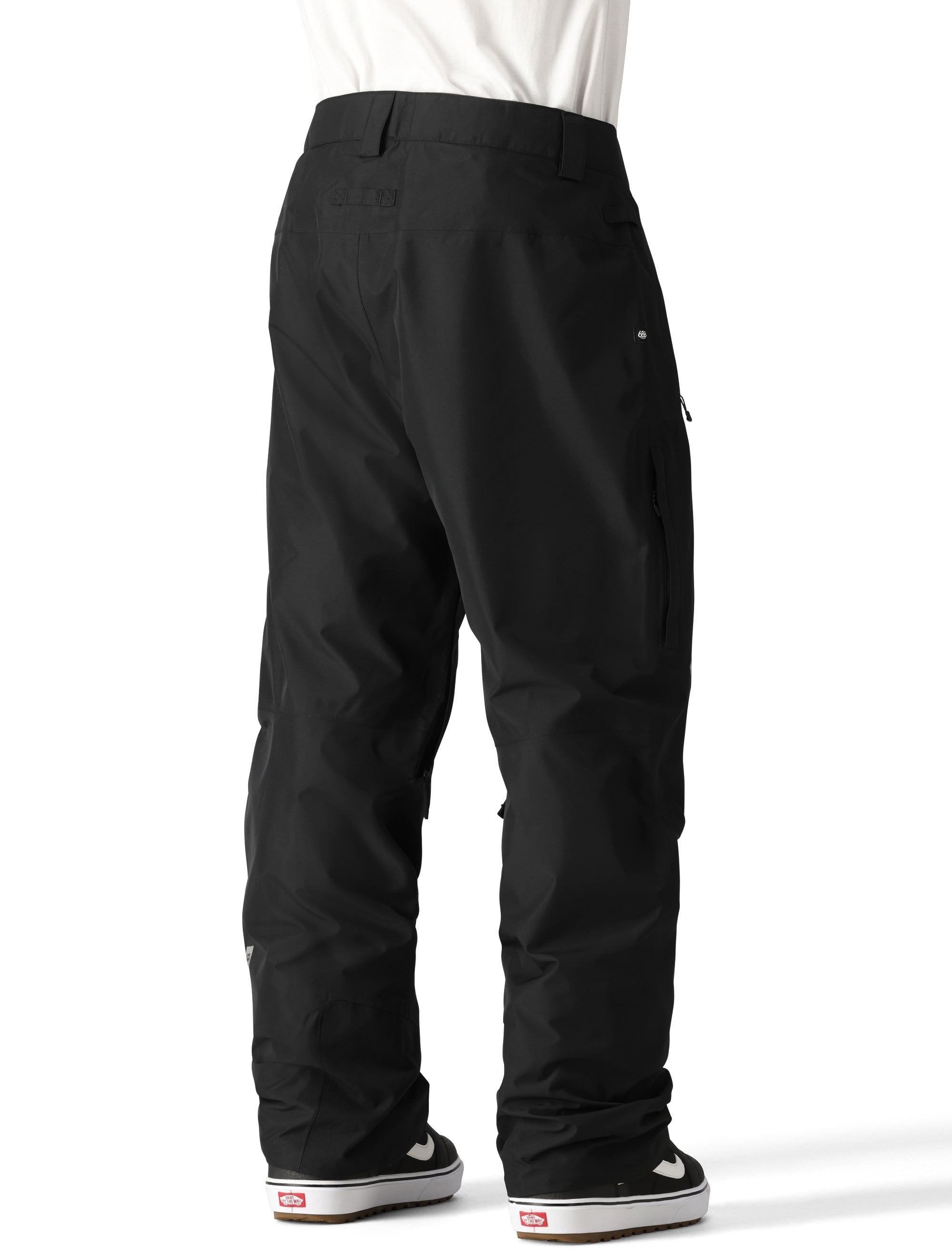 The 686 Men's GORE-TEX Core Shell Pant 2025 is black with a flat front waistband and multiple zippered pockets.