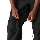The 686 Men's GORE-TEX Core Shell Pant 2025 is black with a zippered fly and mesh vents on each leg.