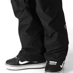 The 686 Men's GORE-TEX Core Shell Pant 2025 is primarily black with white logos and zippers.