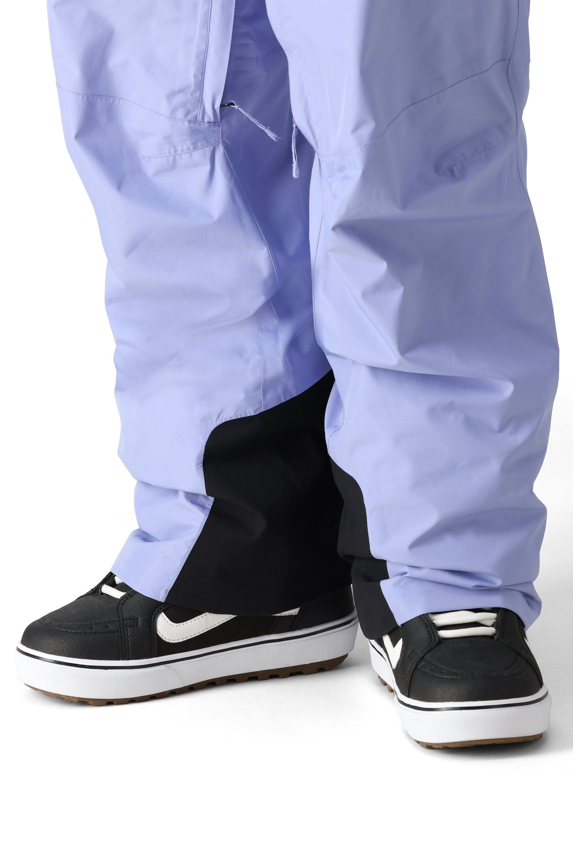 The 686 Men's GORE-TEX Core Shell Pant 2025 has a light purple color with black accents and a drawstring waist.