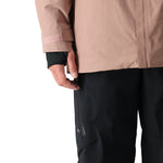 The 686 GORE-TEX GT Shell Jacket 2025 is primarily tan with black accents and a fully zipped front.
